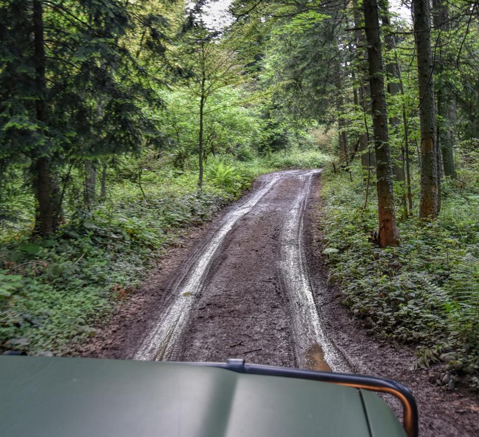 Car driving in a road with mud