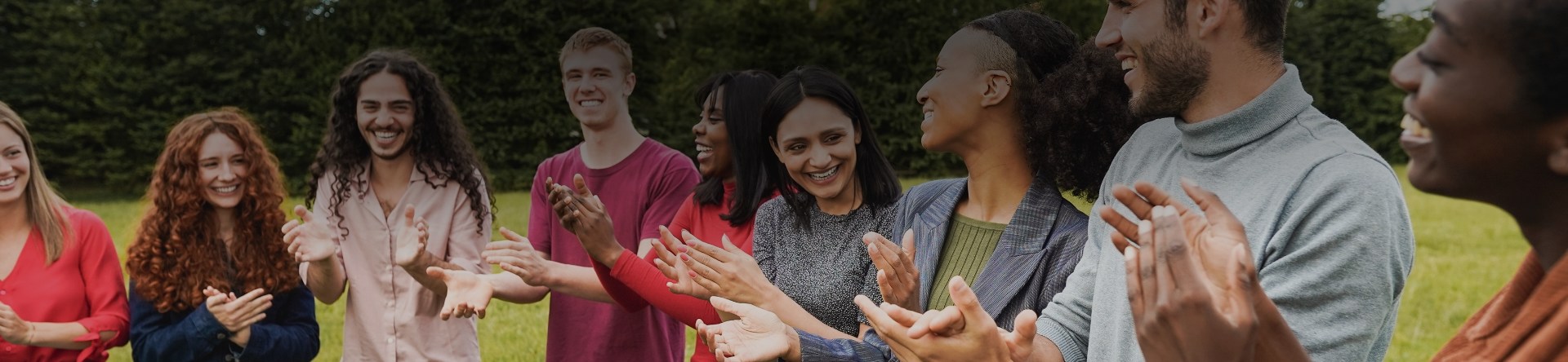 Group of people clapping hands together