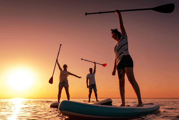 Girls doing paddleboard sunset