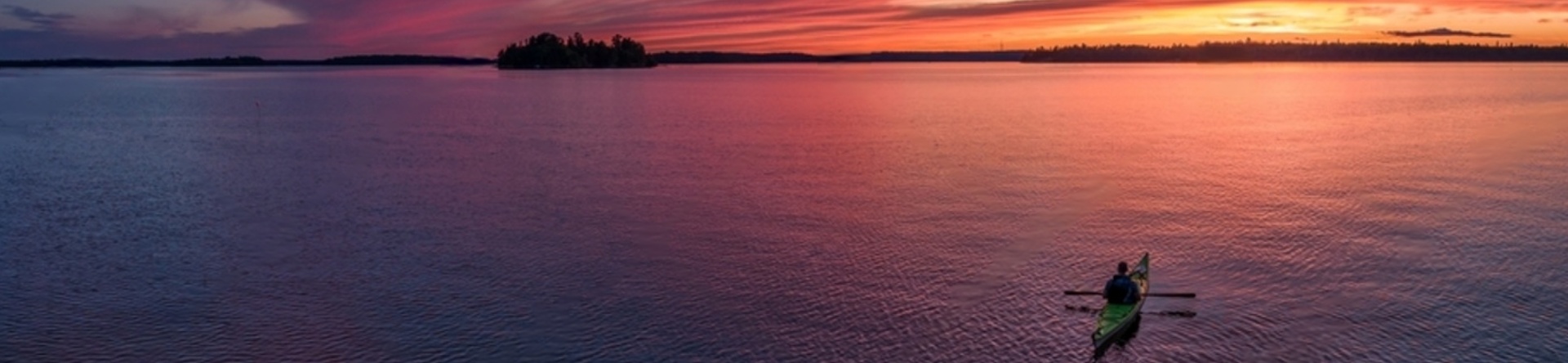 Man doing kayak during sunset