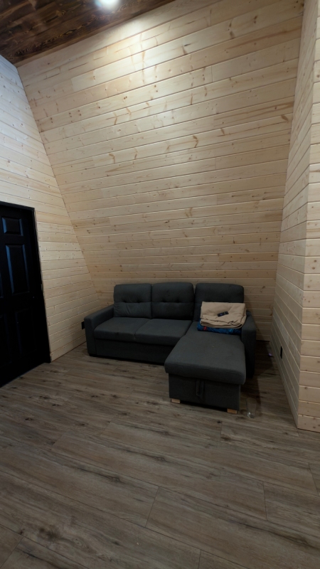 Wood-paneled upstairs lounge at Sustutdene Eco Resort Lodge
